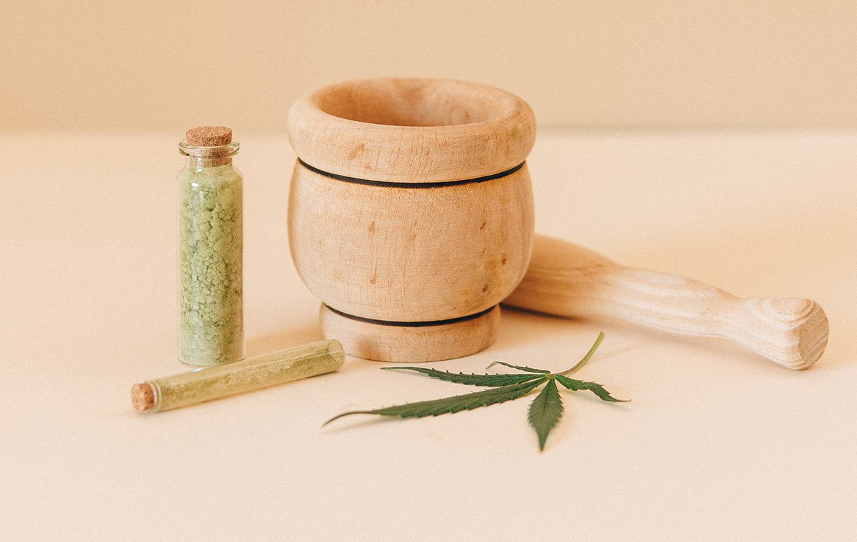 Bottle of Cannabis Beside Mortar and Pestle Bottle of Cannabis Beside Mortar and Pestle